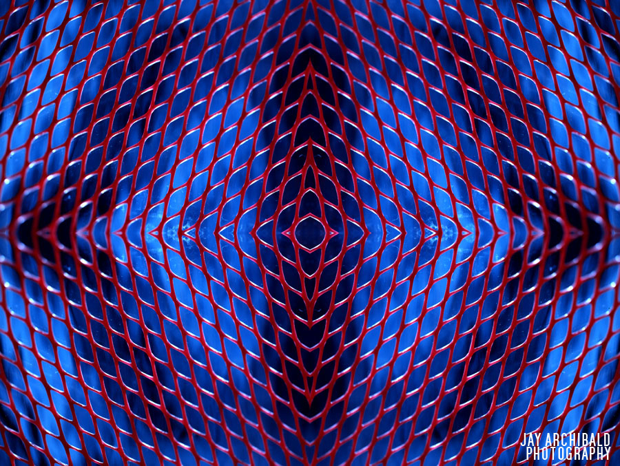Reflected image with red netting used behind a bar, with a matte blue background