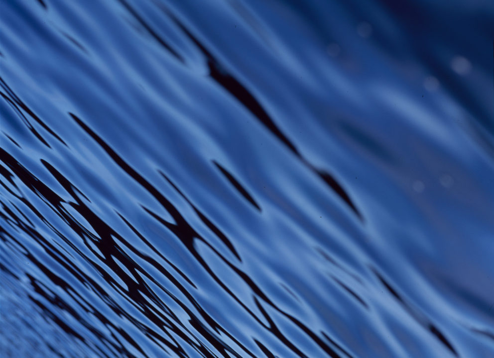 Simple off-center photo of the dark, glassy waters of an Amsterdam canal, 2005